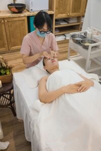 A woman receives a relaxing facial massage in a spa, promoting skin health and relaxation.