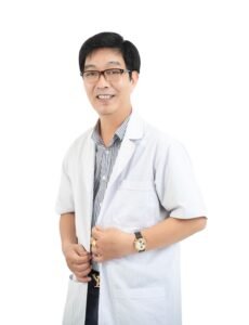 Smiling male doctor in a white coat with glasses, isolated on white background.